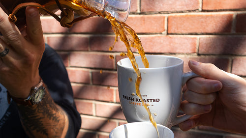 Trick pour using a Chemex coffee maker to pour into two mugs at the same time.