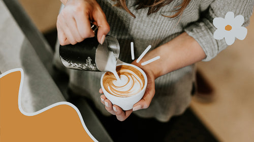 A barista expertly pouring latte art in a cafe.