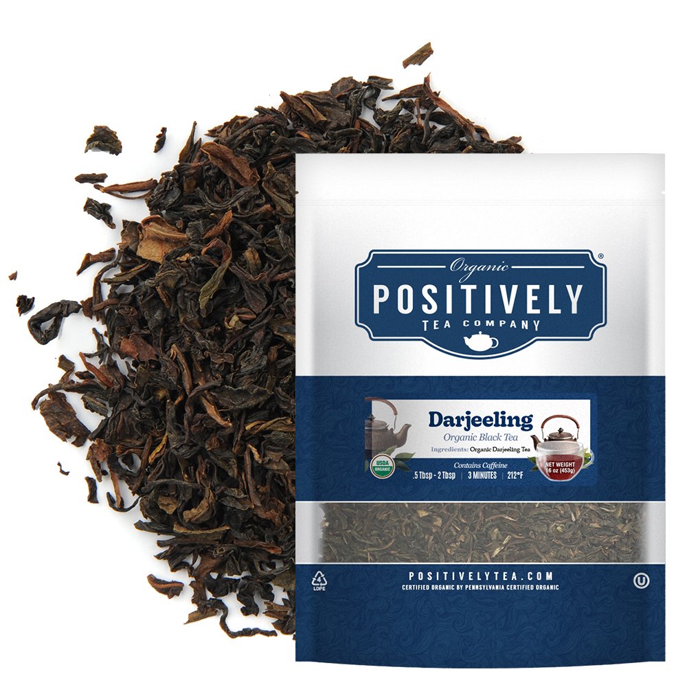 Positively Tea Company Organic Darjeeling black tea, 1 lb bag, displayed with loose leaf tea highlighting its crisp and nuanced flavor profile.

