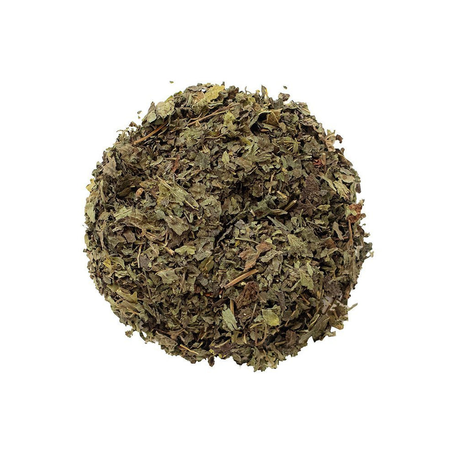 Positively Botanicals Organic Lemon Balm loose leaf herbal tea, showcasing dried leaves with calming aroma.