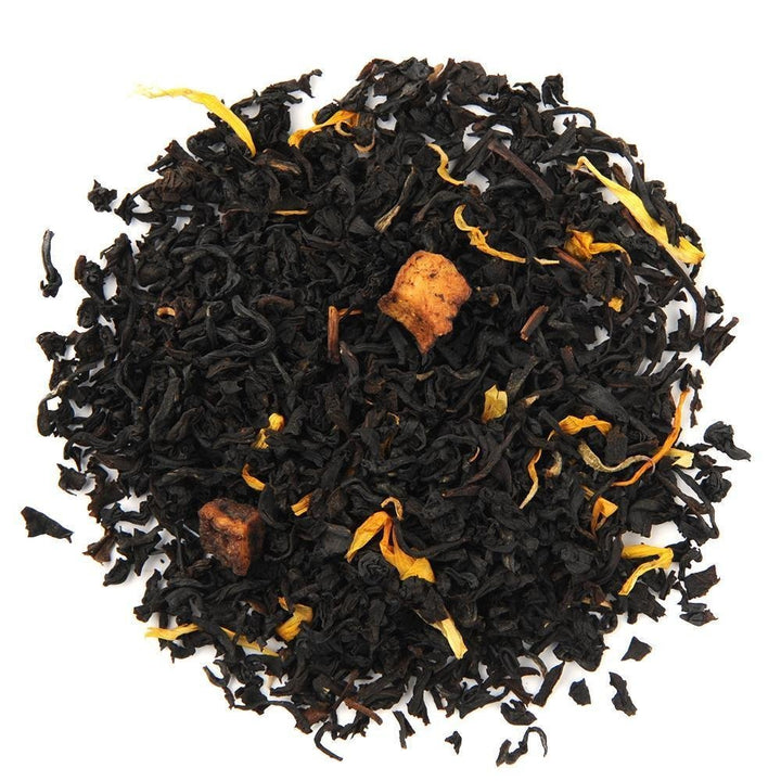 Organic Juicy Peach Black Tea loose leaf blend with dried peach bits and marigold petals, offering a sweet, fruity flavor.