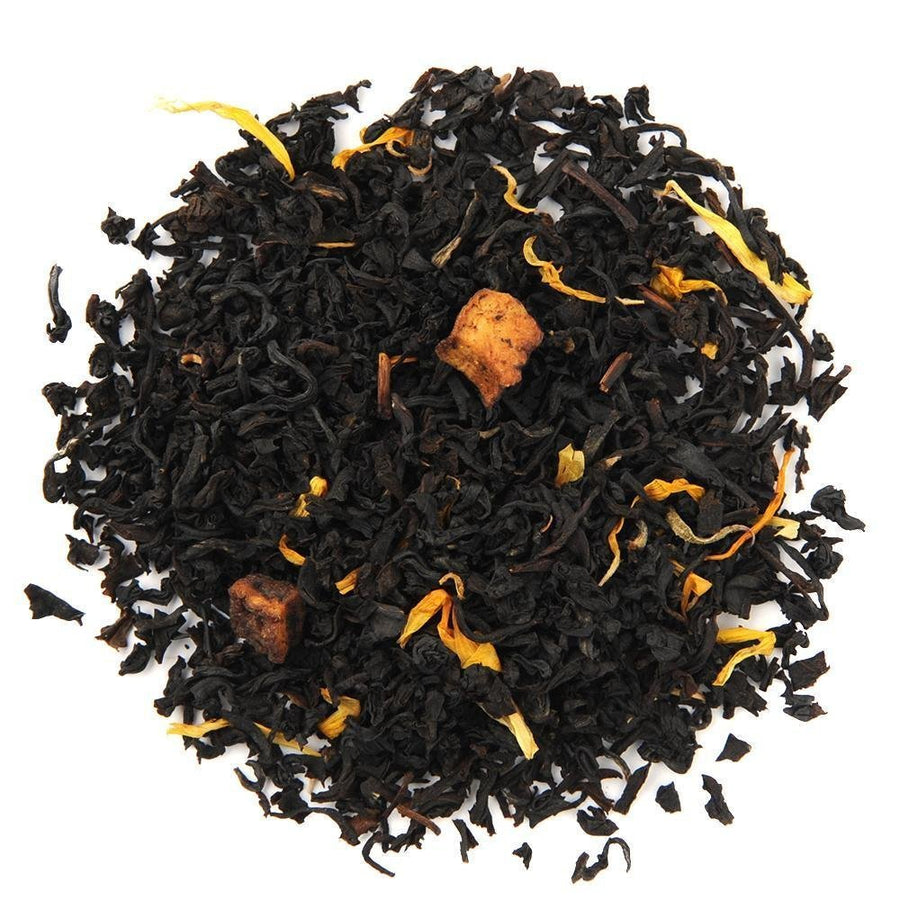 Organic Juicy Peach Black Tea loose leaf blend with dried peach bits and marigold petals, offering a sweet, fruity flavor.