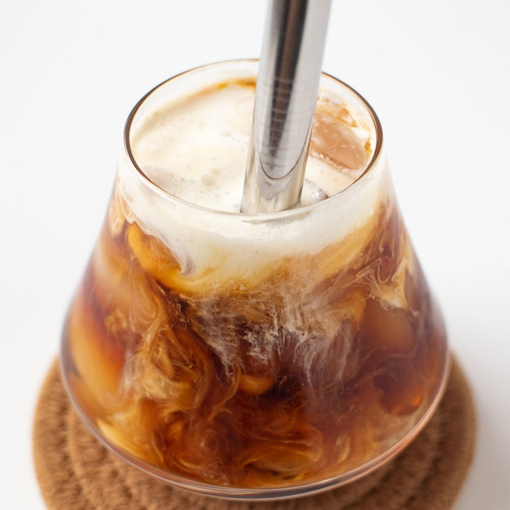 Fresh Roasted Coffee Frostbite Cold Brew in a glass with milk swirl, capturing rich chocolate and nougat notes.