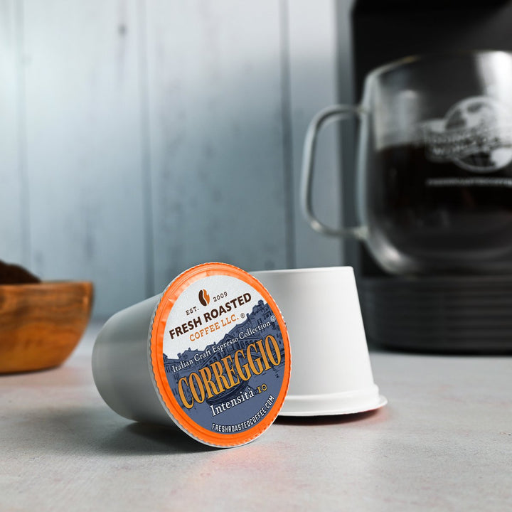 Close-up of Fresh Roasted Coffee Correggio espresso pod on a kitchen counter, part of the Italian Craft Espresso Collection.