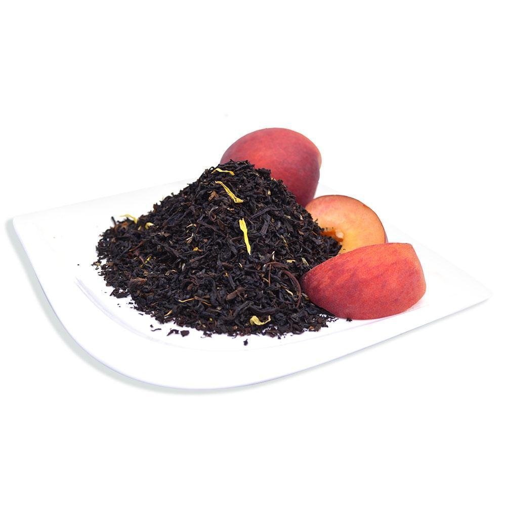 Juicy Peach Black loose leaf tea displayed with fresh peach slices, showcasing a naturally sweet, aromatic tea blend.